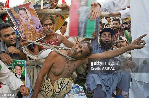 An activist of the Alliance for Restoration of Democracy dances during a rally in Lahore, 10 September 2006. The ARD along with other opposition...