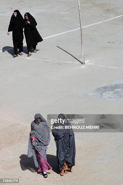 Iranian women walk in the courtyard of the Jamkaran mosque outside the religious city of Qom 120 kms south of Tehran, 08 September 2006. Hundreds of...