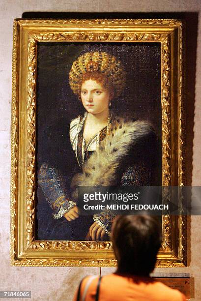 Picture taken 11 September 2006 at the Luxembourg museum in Paris shows a visitor looking at "Portrait d'Isabella d'Este" by Venice-born Tiziano...