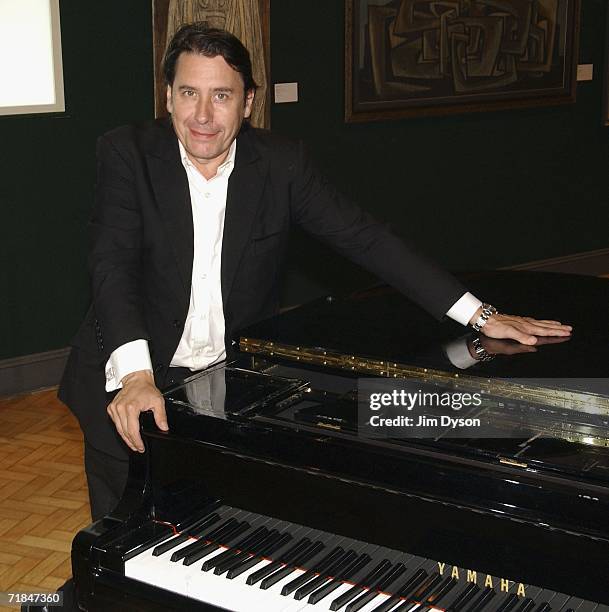 Musician, TV presenter and band-leader Jools Holland poses with his long-serving piano, with which he has accompanied such stars as Tom Jones, Paul...