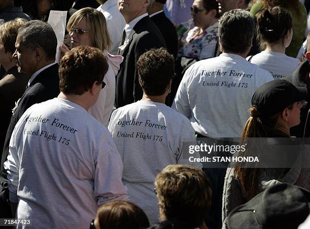 New York, UNITED STATES: People wear shirts commemorating United Airlines flight 175 as families gather at the World Trade Center site, 11 September...