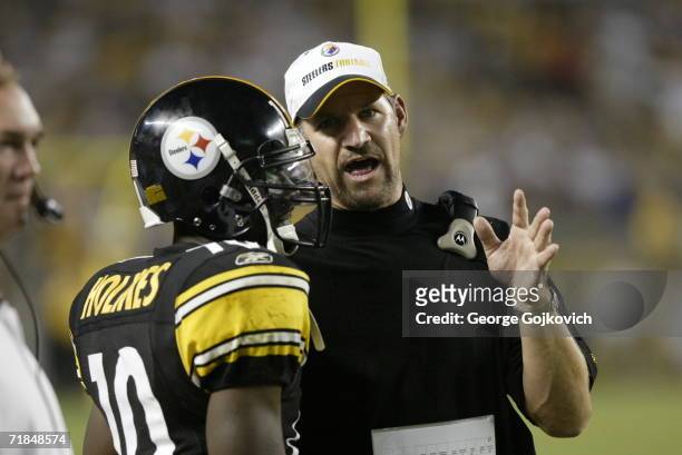 Head coach Bill Cowher of the Pittsburgh Steelers talks with wide receiver Santonio Holmes during a game against the Miami Dolphins at Heinz Field on...