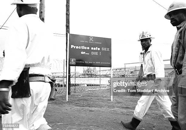 Signs Of The Times - A sign warning miners about the dangers of HIV/AIDS at the Lonmin platinum mine in the Marikana area of South Africa. 17,000 men...