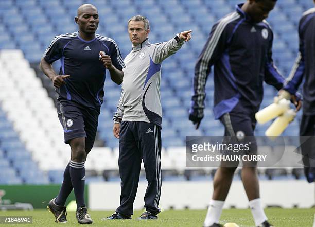 United Kingdom: Chelsea football Club manager Jose Mourinho instructs his team as player Geremi runs past during a team practice at Stamford Bridge...