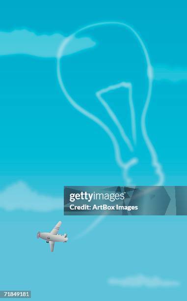 biplane forming a light bulb with its vapor trail - small plane stock illustrations