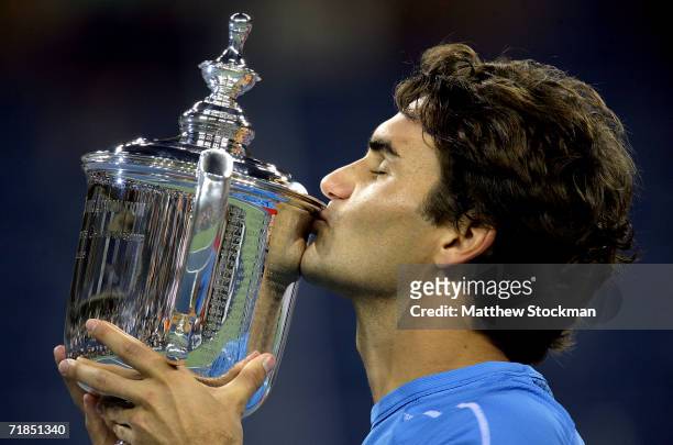 Roger Federer of Switzerland kisses the championship trophy after defeating Andy Roddick in the men's final of the U.S. Open at the USTA Billie Jean...