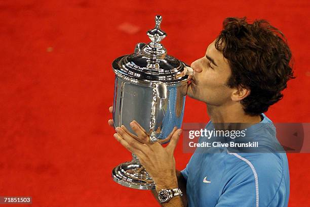 Roger Federer of Switzerland kisses the championship trophy after defeating Andy Roddick in the men's final of the U.S. Open at the USTA Billie Jean...