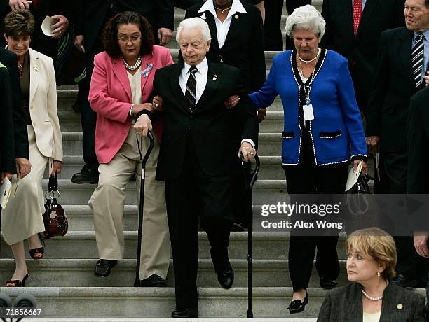 With the help of two Senate staffers, Cindy Hasiak and Mary Arnold , U.S. Sen. Robert Byrd walks down the East Steps of the U.S. Capitol with other...