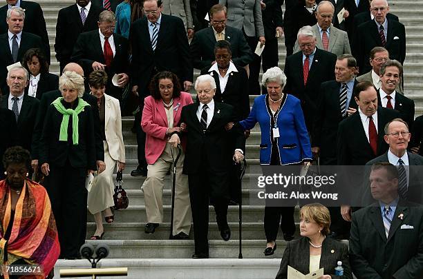 With the help of two Senate staffers, Cindy Hasiak and Mary Arnold , U.S. Sen. Robert Byrd walks down the East Steps of the U.S. Capitol with other...