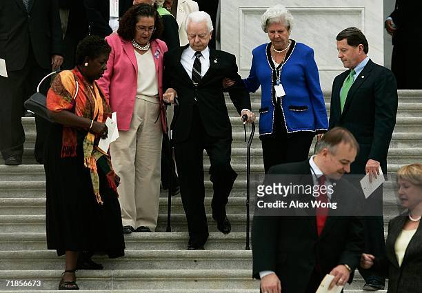 With the help of two Senate staffers, Cindy Hasiak and Mary Arnold , U.S. Sen. Robert Byrd walks down the East Steps of the U.S. Capitol with other...