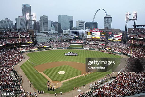 Members of the St. Louis police and fire departments display a U.S. Flag in center field as the national anthem is played on the fifth anniversary of...