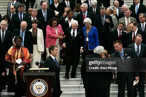 With the help of two Senate staffers, Cindy Hasiak and Mary Arnold , U.S. Sen. Robert Byrd walks down the East Steps of the U.S. Capitol with other...