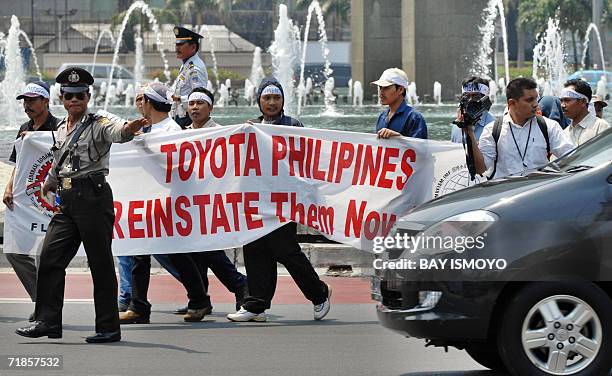 Dozens of Indonesian workers hold a solidarity protest, in Jakarta 12 September 2006, to support car giant Toyota's workers in the Philippines....