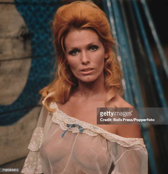 American actress Victoria George, who appears in the film 'The Last Rebel', pictured wearing a sheer almost transparent negligee style dress in her...