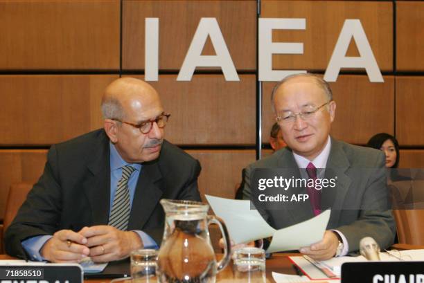 International Atomic Energy Agency Director-General Mohamed ElBaradei and IAEA Chairman Yukiya Amano of Japan review documents in Vienna 12 September...