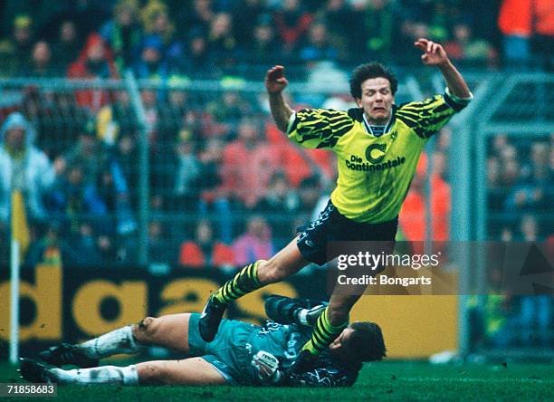 Goalkeeper Bernd Dreher of Uerdingen and Andreas Moeller of Dortmund battle for the ball during the bundesliga match between Borussia Dortmund and...