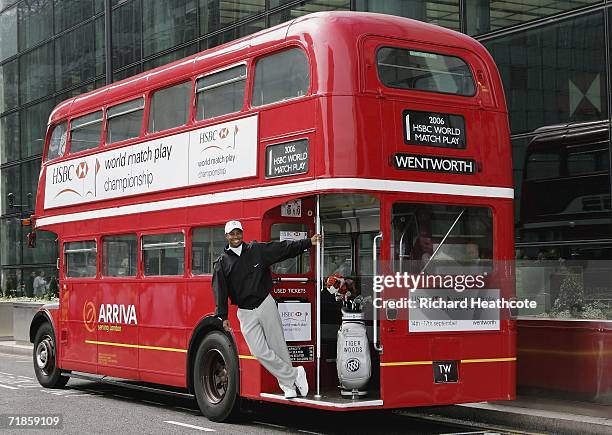 Tiger Woods of the USA poses on a red double decker London bus heading for The Wentworth Club during the launch of the HSBC World Match Play at...