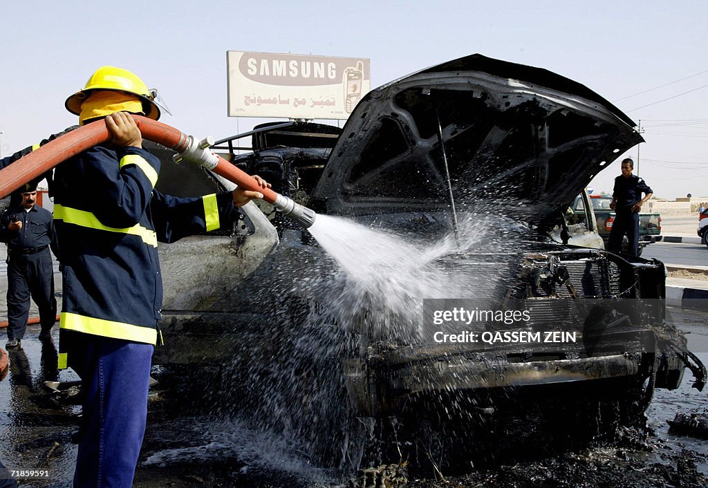 Iraq Fire Engine An Iraqi firefighter douses fire that swept over a truck at the site ...