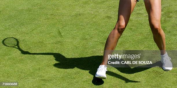 Wimbledon, UNITED KINGDOM: The shadow of Russian tennis player Maria Sharapova falls on a grass court at Wimbledon, in south London, 23 June 2006....