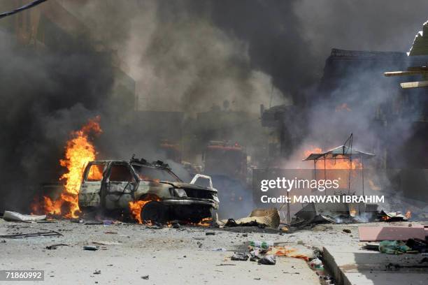Trucks and cars burn following a explosion in front of a courthouse in the northern Iraqi oil city of Kirkuk 23 July 2006. A car bomb killed 15...