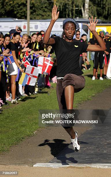 Miss Namibia Anna Svetlana Nashandi performes the long jump during the Miss Sports competition as other Miss World contestants cheer her in Mazurian...