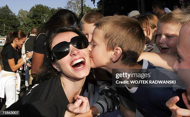 Miss Lebanon Annabella Hilal recives a kiss from a Polish boy after the Sport competition in Mazurian lakes region city of Gizycko, 12 September...