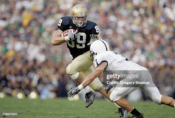 Tight end John Carlson of the Notre Dame Fighting Irish runs the ball as Safety Anthony Scirrotto of the Penn State Nittany Lions defends on...
