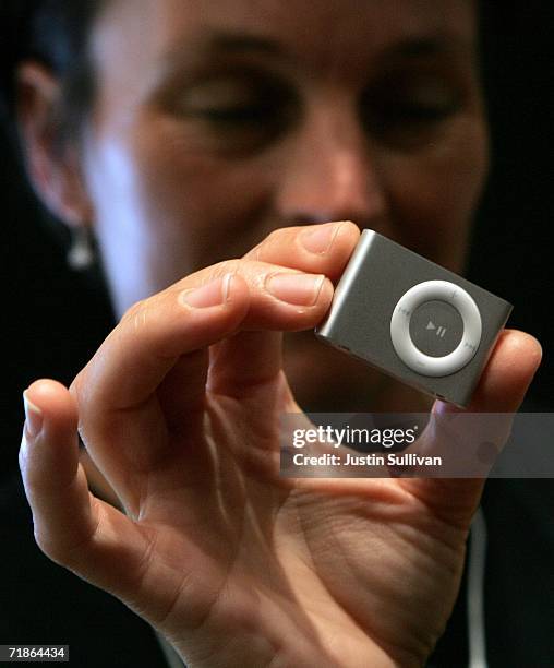 Woman holds a new iPod Shuffle at an Apple media event September 12, 2006 in San Francisco, California. Apple CEO Steve Jobs announced new iPods and...