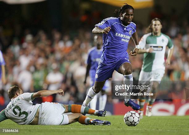 Didier Drogba of Chelsea jumps over the challenge from Petri Pasanen of Werder Bremen during the UEFA Champions League Group A match between Chelsea...