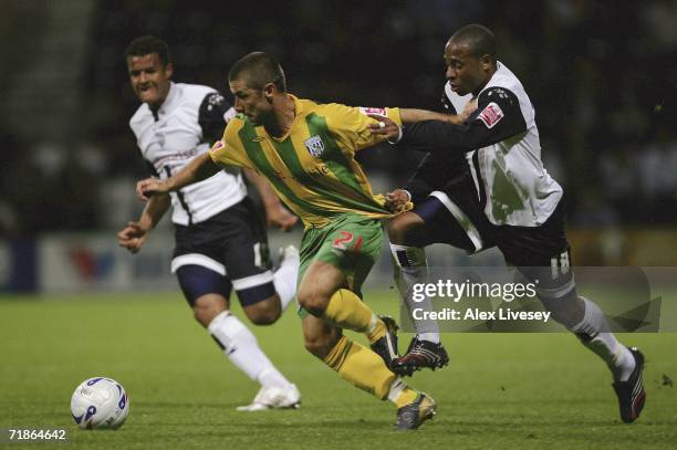 Kevin Phillips of West Bromwich Albion is pulled back by Matt Hill of Preston North End during the Coca-Cola Championship match between Preston North...