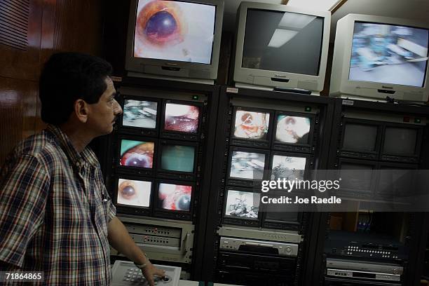 Video monitors record the doctors working in the operating room on the eyes of a patient participating in "Operacion Milagro" September 12, 2006 at...