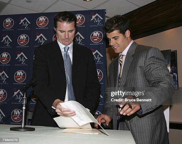 General Manager Garth Snow signs Rick DiPietro to a 15 year contract with the New York Islanders on September 12, 2006 at Nassau Coliseum in...