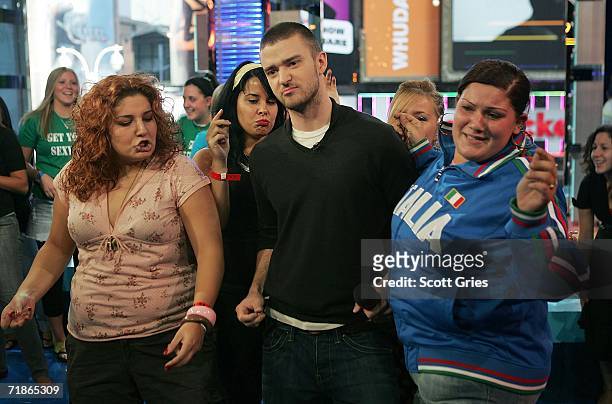 Singer Justin Timberlake dances with audience members onstage during MTV's Total Request Live at the MTV Times Square Studios on September 12, 2006...