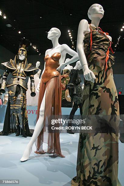 New York, UNITED STATES: A camouflage evening dress by designer John Galliano for Chrisitan Dior and a metal bustier paired with a silk skirt by...