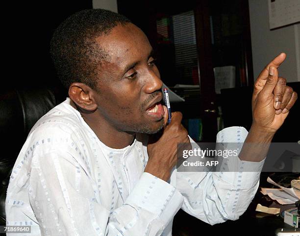 The chairman of Nigeria's Economic and Financial Crime Commission, Nuhu Ribadu, speaks on the phone 12 September 2006 from his office in Abuja....