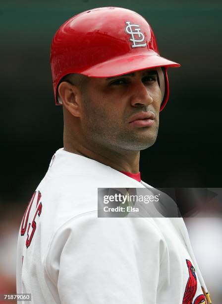 Albert Pujols of the St. Louis Cardinals looks for direction from manager Tony LaRussa before he bats in the sixth inning against the Houston Astros...