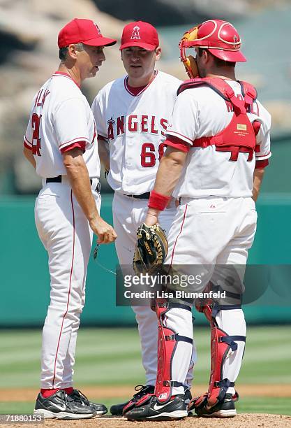 Pitching coach Bud Black, pitcher Joe Saunders and catcher Mike Napoli of the Los Angeles Angels of Anaheim have a meeting on the mound in the third...