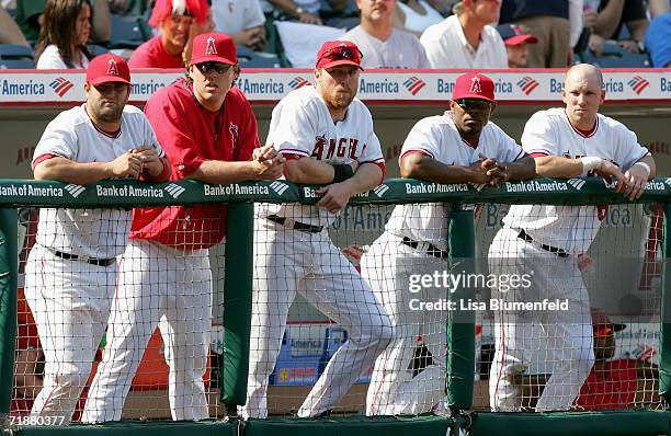 Catcher Mike Napoli, pitcher John Lackey, Darin Erstad, Howie Kendrick and Tommy Murphy of the Los Angeles Angels of Anaheim look on from the dugout...