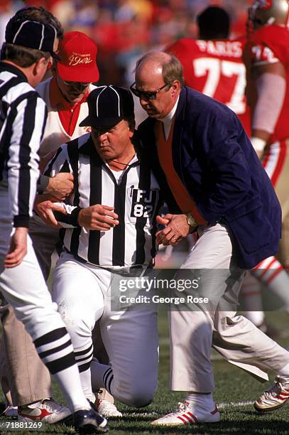 Field judge Pat Mallette gets helped off the grass after getting knocked down during a 1989 NFC Divisional Playoffs game between the Minnesota...