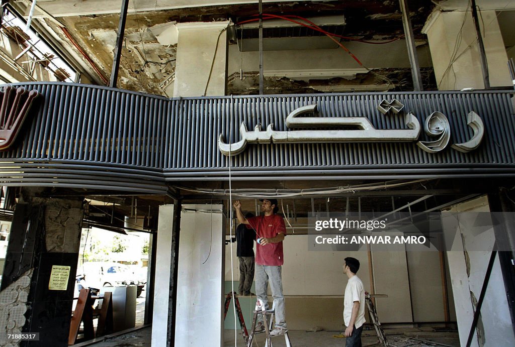 Lebanese workers reconstruct a shop at d