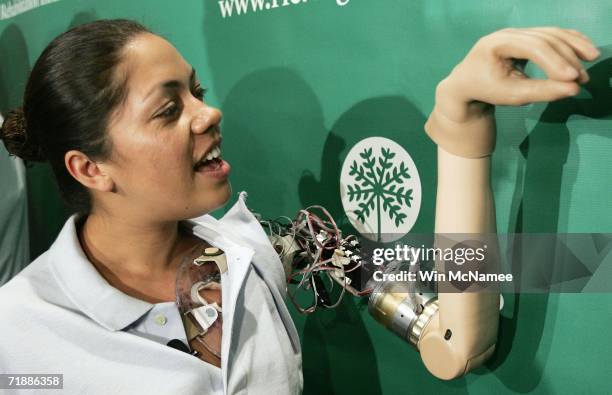 Claudia Mitchell demonstrates the functionality of her "bionic arm" during a news conference on September 14, 2006 in Washington, DC. Mitchell is the...