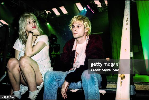 Kurt Cobain , lead singer of American grunge band Nirvana, backstage with his wife Courtney Love, singer with the band Hole, early 1990s.