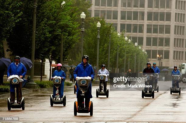 Group of Segway riders make their way down Pennsylvania Ave.in the rain September 14, 2006 in Washington, DC. Segway Inc. Announced that they have...