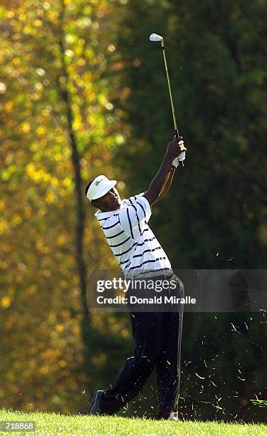 Vijay Singh of the International Team hits out from the fairway during his match against Tiger Woods and Notay Begay of the USA in the first round of...