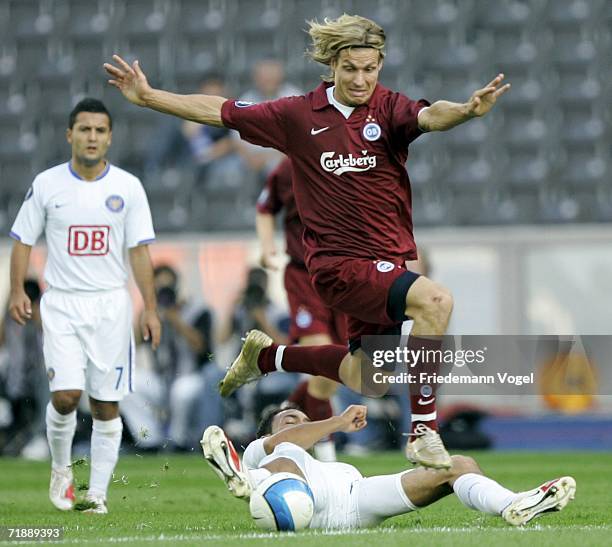 Kevin-Prince Boateng of Hertha tussels for the ball with Tobias Grahn of Odense during the UEFA Cup first leg match between Hertha BSC Berlin and...