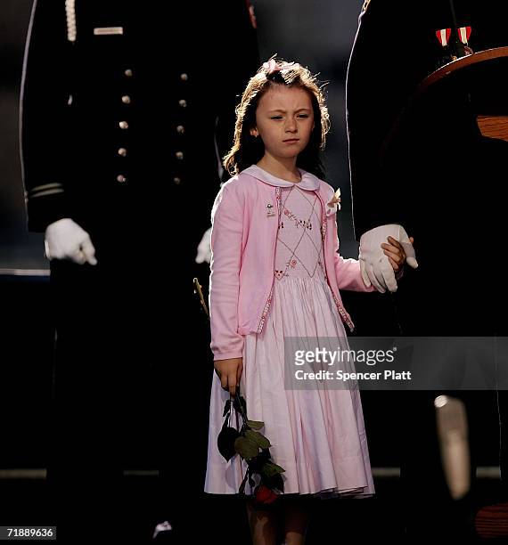 The daughter of police officer Moira Smith who was killed on 9-11, Patricia Smith, holds the hand of her father James Smith on stage during the...