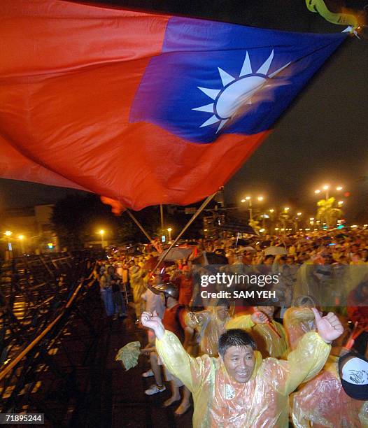 Protesters give a thumbs down sign during a demonstration in Taipei 15 September 2006. Tens of thousands of Taiwanese protestors were expected to...