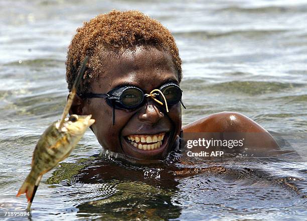 Rabaul, PAPUA NEW GUINEA: A Tolai child, Minio Rafael, spearfishes off Tavui Point, 14 September 2006, after volcanic ash and pumice destroyed the...