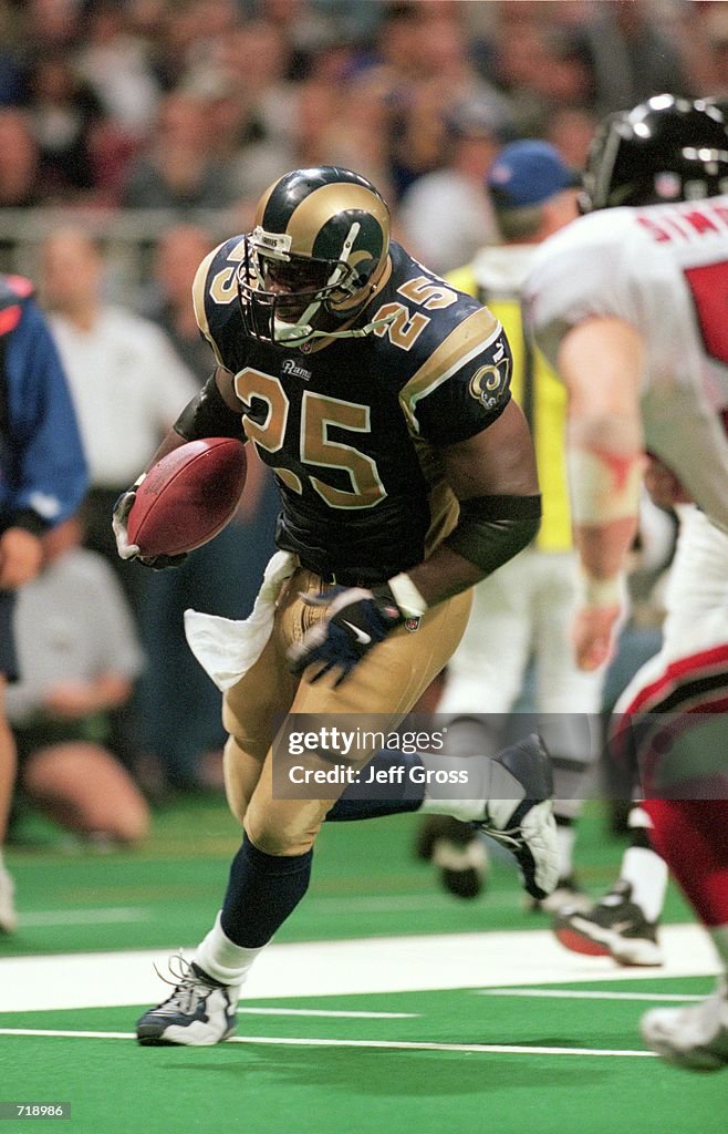 Robert of the St. Louis Rams runs with the ball during the