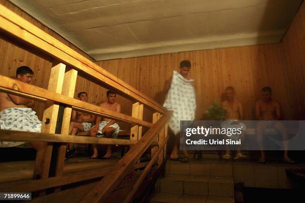 Khazak men sit in the Finnish sauna at the Arsan hot baths, where male-only patrons can choose between Russian, Turkish or Swedish treatments August...